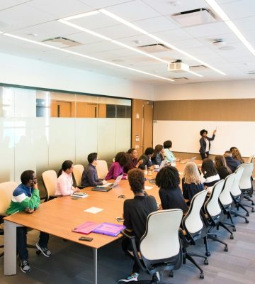 Professional team engaged in a collaborative boardroom meeting with a presentation in progress.